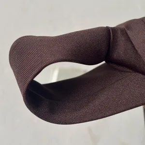 Primer plano detallado de la corbata marrón oscuro, mostrando la fina textura de tela.