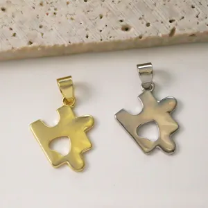 Detailed view of gold and silver puzzle heart pendants, perfect for DIY jewelry making and necklace.