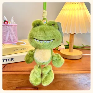 Close-up detail of the cute green frog plush keychain pendant with soft fabric and teeth.