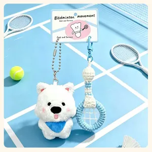 Close-up detail of cute white dog plush toy paired with a knitted badminton racket keychain.