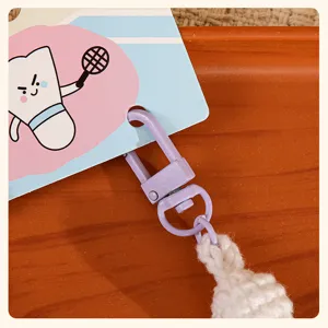 Detailed view of the cute badminton puppy plush toy keychain with metal hook and card.