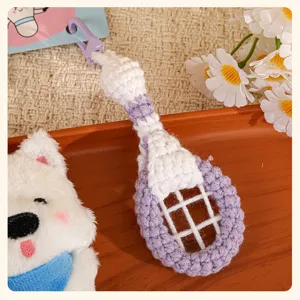Handmade crochet badminton racket and cute plush dog keychain pair, charming bag pendant accessory.