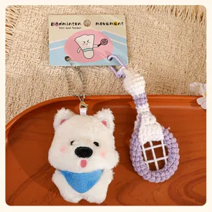 Close-up detail view of the cute plush puppy dog and badminton racket keychain charm.