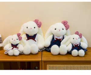 Cute lop-eared plush rabbit doll detail view, wearing sailor dress and lovely bow hair accessory.