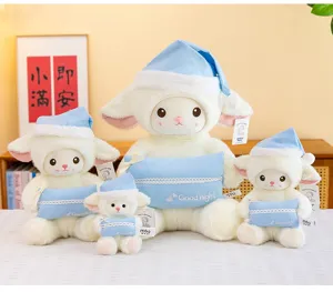 Detailed shot of cute plush lamb doll set with blue santa hats and pillows for sweet gift.