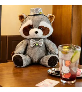 Detailed view of the cute gentleman raccoon plush toy wearing a sparkling hat and bow tie.