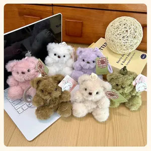Plush teddy bear keychain detail, fluffy stuffed animal pendant, cute bag charm.