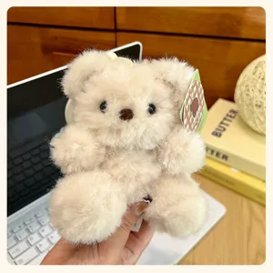 Cute fluffy beige teddy bear plush toy pendant, soft hanging ornament for keys, bag charm detail.