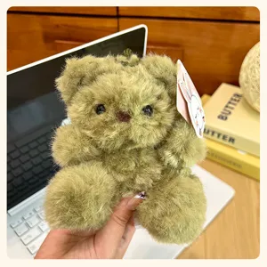 Fluffy green teddy bear plush toy keychain, cute fluffy stuffed animal bag pendant detail.