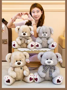 Cute plush teddy bear doll toy with plaid bow and heart paw pads for kids birthday gift.