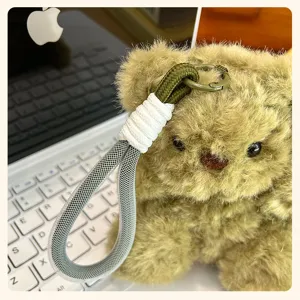 Cute plush teddy bear keychain with braided lanyard, fluffy toy pendant for bags and keys.