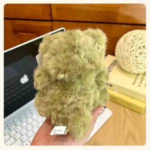 Fluffy green bear plush toy detail, cute mini keychain pendant for desk decor and bags.
