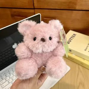 Fluffy pink bear plush pendant close-up, soft toy keychain detail, cute bag charm accessory.