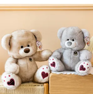 Cute plush teddy bear toy with heart footpads, soft stuffed animal doll gift for kids.