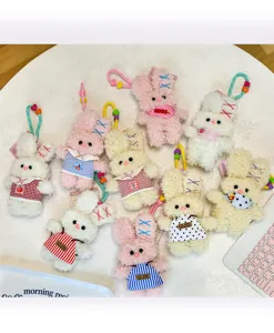 Detailed close-up of cute plush rabbit keychains, soft toy pendants with dresses.