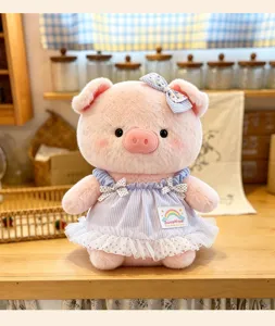 Cute pink plush pig stuffed toy featuring a blue striped dress and sweet bow, perfect gift.