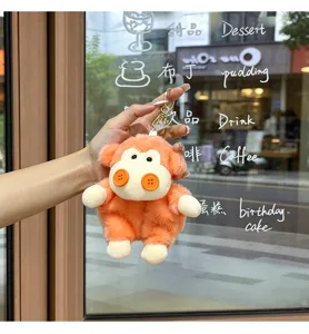 Cute orange plush doll keychain with button design, soft stuffed animal bag pendant toy.