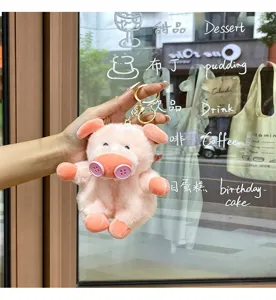 Cute plush pig keychain with button nose, soft stuffed animal bag pendant for keys and decor.