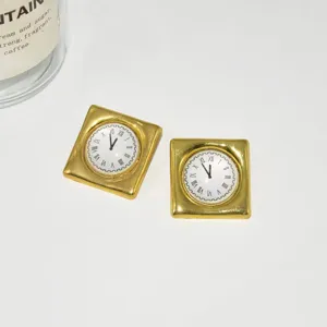 Detail view of vintage gold square clock earrings, showing exquisite retro jewelry design.