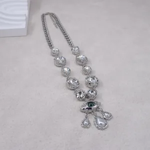 Detailed close-up view of vintage evil eye crystal necklace with pearls and rhinestones.