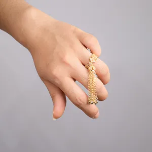 Detail shot of the elegant bow tassel ring, highlighting delicate zircon and cascading chains.