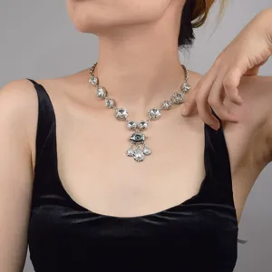 Detailed shot of European vintage evil eye crystal pearl clavicle chain jewelry piece.