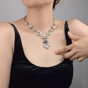 Evil eye crystal pendant necklace for women, elegant silver clavicle chain with pearl dangles.