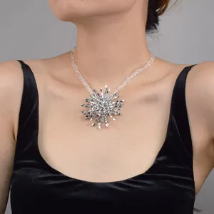 Stunning crystal starburst pendant necklace close-up shot with sparkling rhinestone chain.