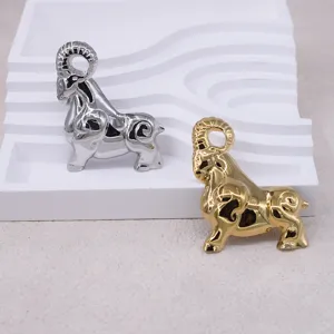 Detailed view of retro 3D zodiac ram brooches in gold and silver, elegant animal accessories.