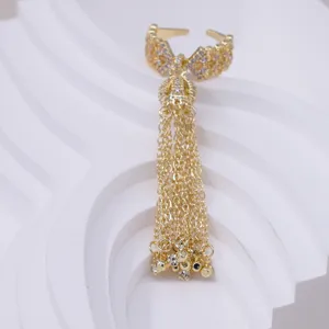 Gold open bow ring with long tassel chains, elegant zircon detail for stylish finger wear.