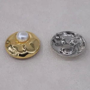 Detail shot of French vintage pearl metal brooch showing front textured design and back pin.