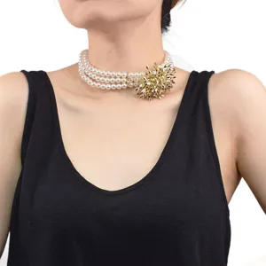 Three-layer faux pearl choker necklace with striking gold firework ball pendant for evening party.