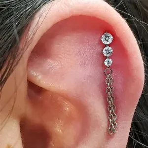 Titanium cartilage piercing earring featuring three sparkling stones and delicate chain tassel.