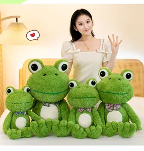 Cute green frog plush toy scene detail showing multiple sizes and soft stuffed pillow doll.