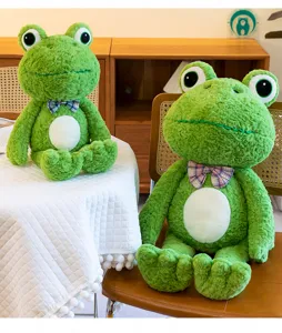 Cute green frog plush toy detail, fluffy curly fur and plaid bow tie, soft stuffed doll room decor.