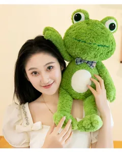 Cute green frog plush toy detail shot, soft stuffed animal doll with plaid bow tie for kids.