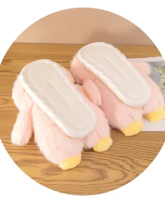 Plush cartoon penguin slippers detail, anti-slip soft soles, fluffy pink indoor winter wear.