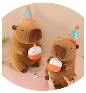 Cute capybara plush toy holding birthday cake with party hat, soft stuffed animal gift for kids.