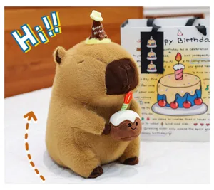 Detailed close-up of adorable capybara plush toy wearing a birthday hat with a mini cake.