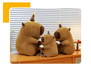 Capybara plush toy set featuring cute stuffed animals holding birthday cakes with party hats.