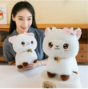 Cute white plush alpaca sheep toy detail view, featuring pink flower and colorful bead necklace.