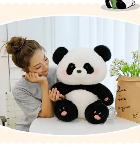 Cute giant panda plush toy detail showing soft fur and pink paw pads in cozy room setup.