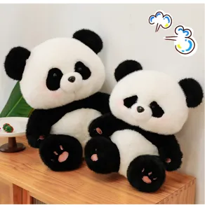 Giant panda plush toy detail showing soft black and white fur and cute sitting posture on wooden table.