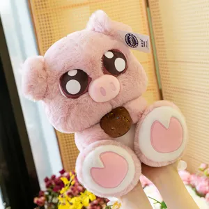 Cute big-eyed pink pig plush toy doll holding a cookie, soft stuffed animal claw machine prize.