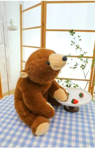 Cute brown plush bear toy sitting on blue checkered tablecloth with strawberries in scene detail.