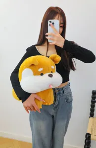 Detailed shot of the cute plush dog toy held by model, soft fabric and lovely design.