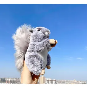 Close-up detail of the fluffy gray simulation squirrel plush toy holding a cute acorn in hand.