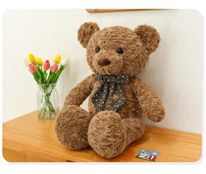 Grand ours en peluche marron avec noeud papillon, adorable animal en peluche cadeau pour enfant.