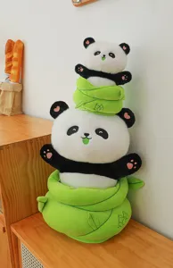Detail view of cute panda plush toy stacked with green bamboo shoot design, soft material.