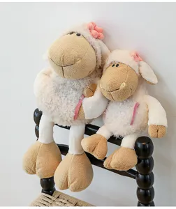 Cute plush sheep toys detail shot, featuring soft fluffy fabric and lovely pink flower decor.